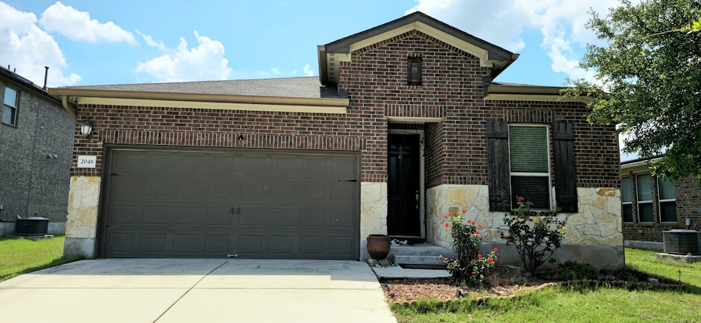View of front of home featuring brick siding, con