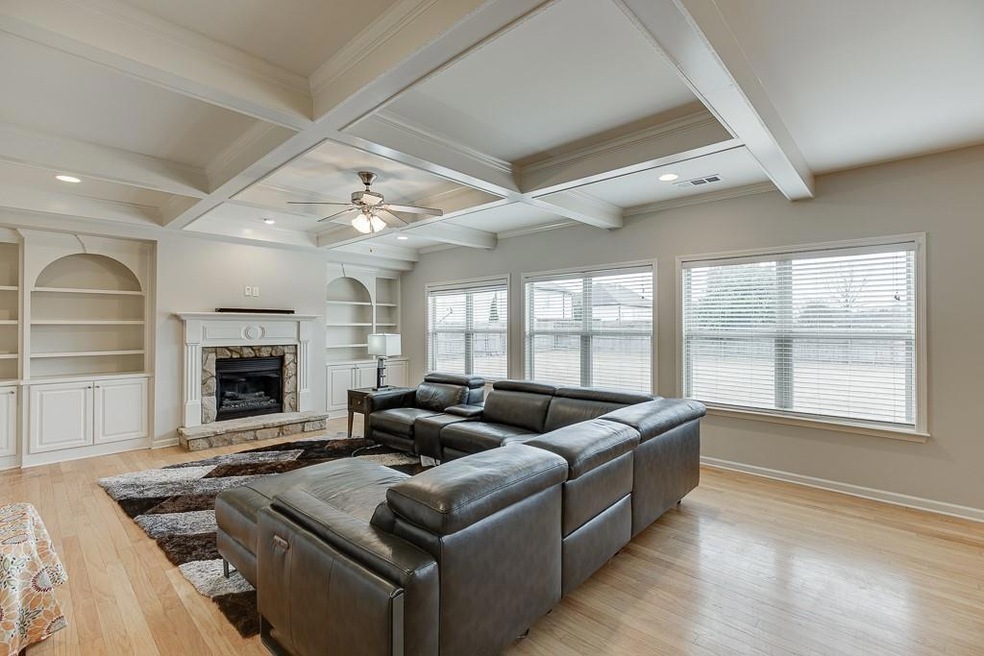 cozy fireplace and coffered ceilings