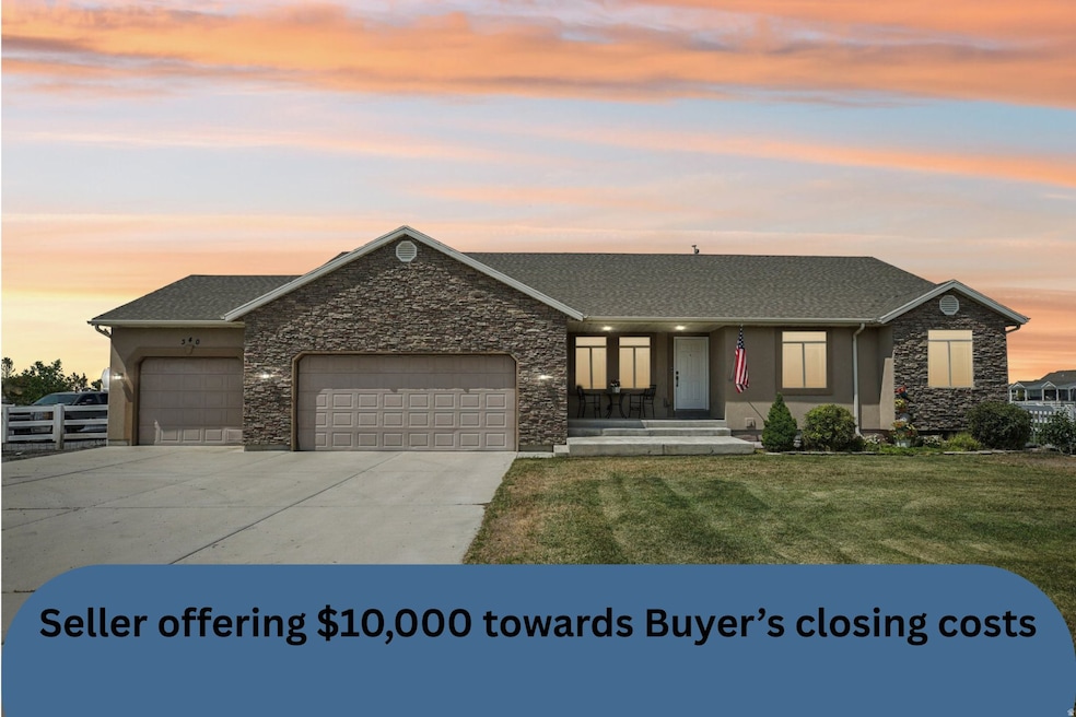 Single story home featuring stone siding, a porch, an attached garage, driveway, and a front yard