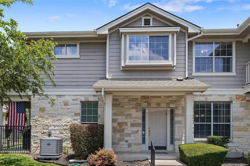 Townhome / multi-family property with stone sidin