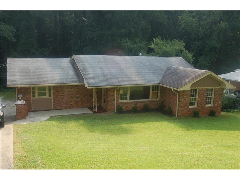 Front of the home with nicely landscaped yard