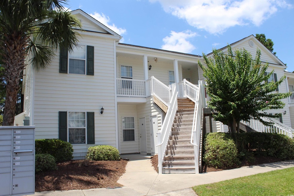 View of front of house with stairs and covered porch