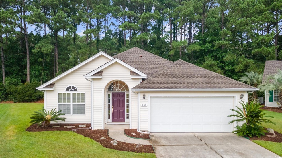 Ranch-style house with a garage and a front lawn