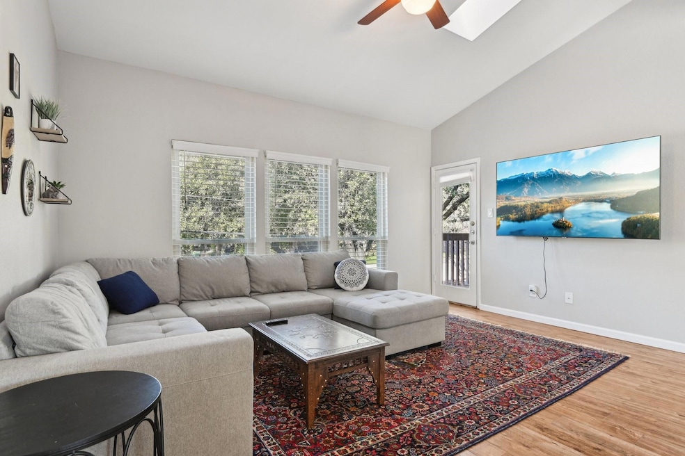 Living area with baseboards, lofted ceiling with s