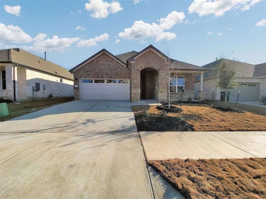 Ranch-style home with an attached garage, brick s
