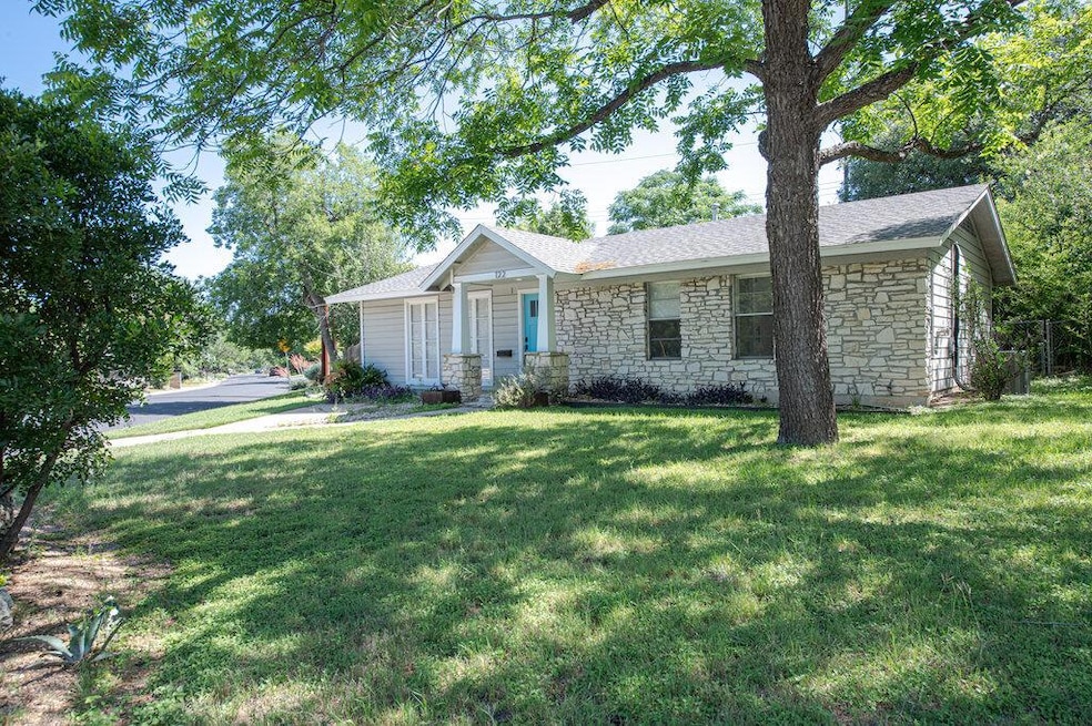 Single story home featuring stone siding, a front