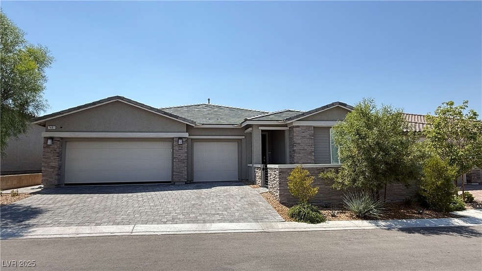Single story home featuring decorative driveway, a