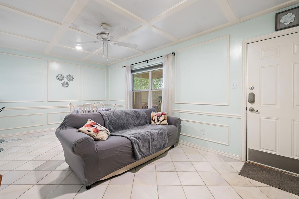 Living room featuring a decorative wall, a ceilin