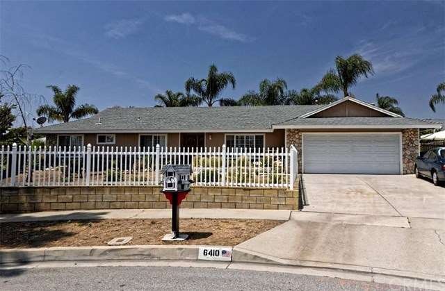 Front of house showcasing white picket fence and c