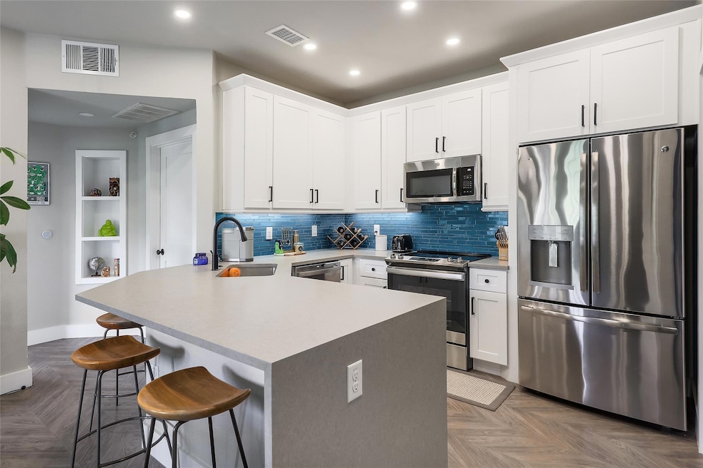 Kitchen with stainless steel appliances, a sink, 