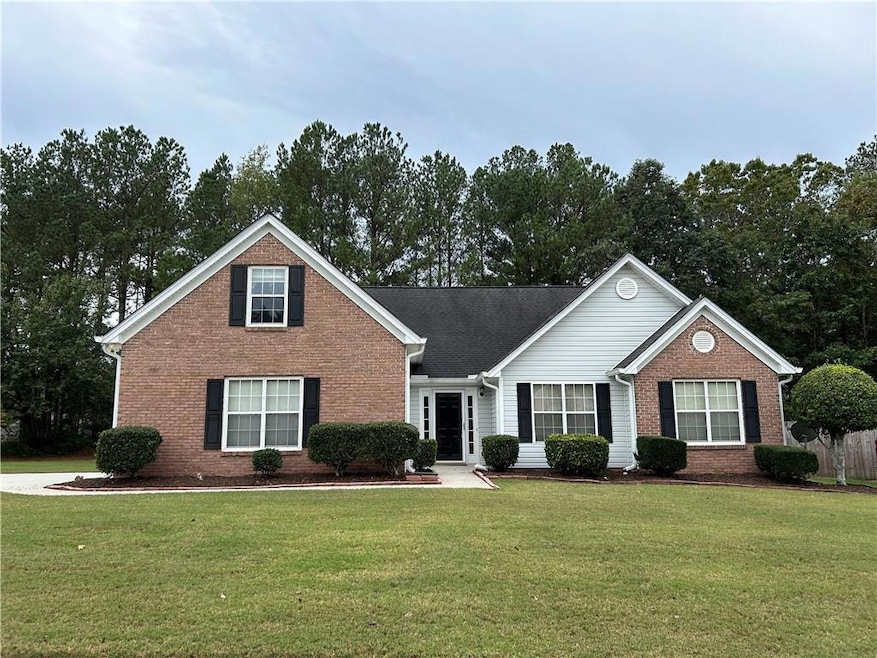 Front of home featuring a beautiful front lawn.