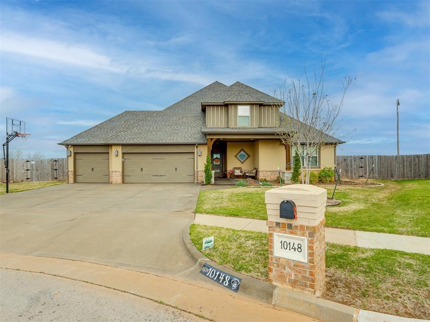 View of front of home with a front lawn and a gara