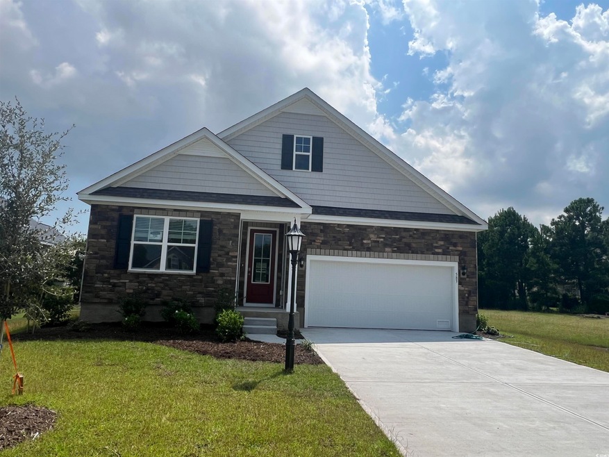 View of front of home with a front yard and a garage