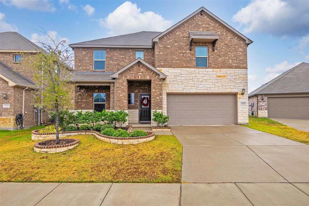 Front of property featuring a garage and a front y