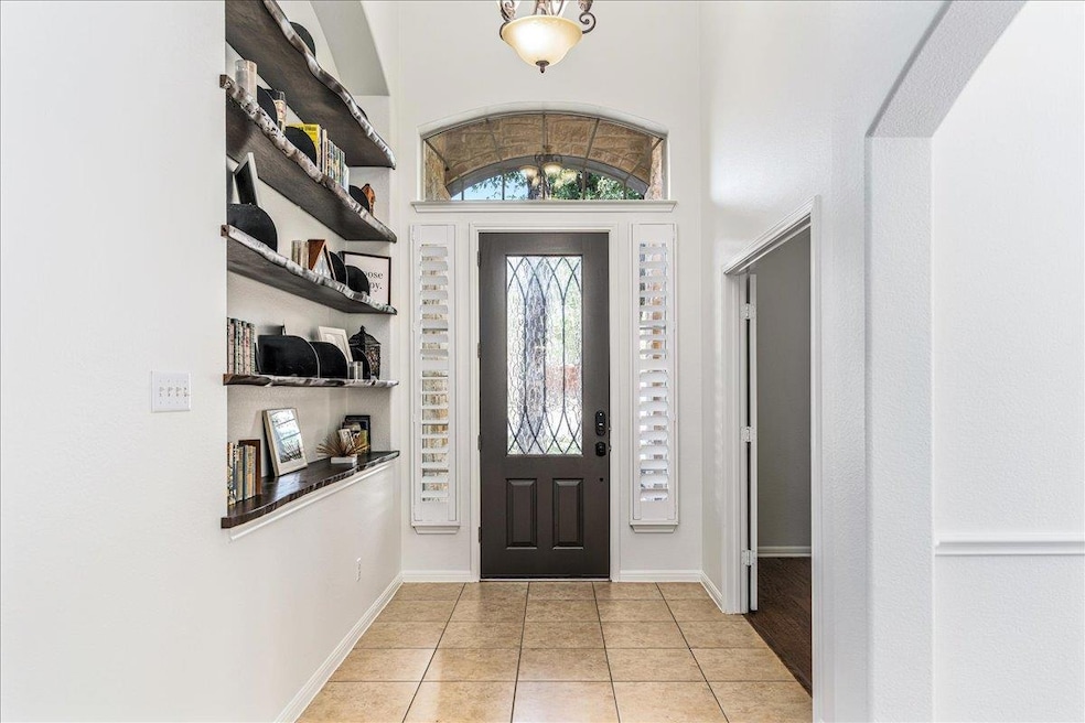 Entryway with light tile patterned flooring and a