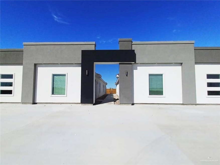 Back of house featuring stucco siding