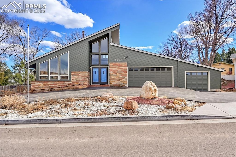 Mid-century home with curved driveway and 3 car ga