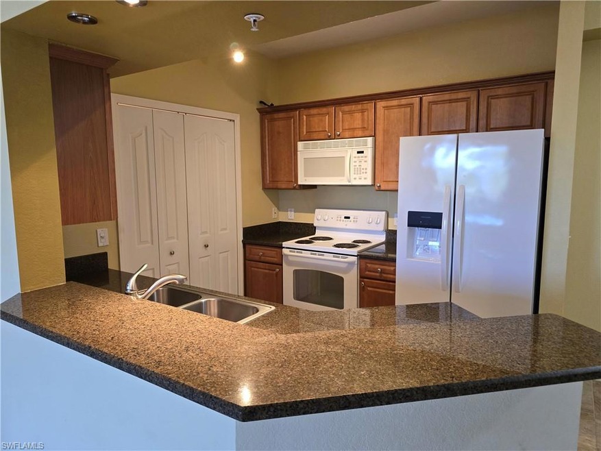 Kitchen with sink, kitchen peninsula, and white ap