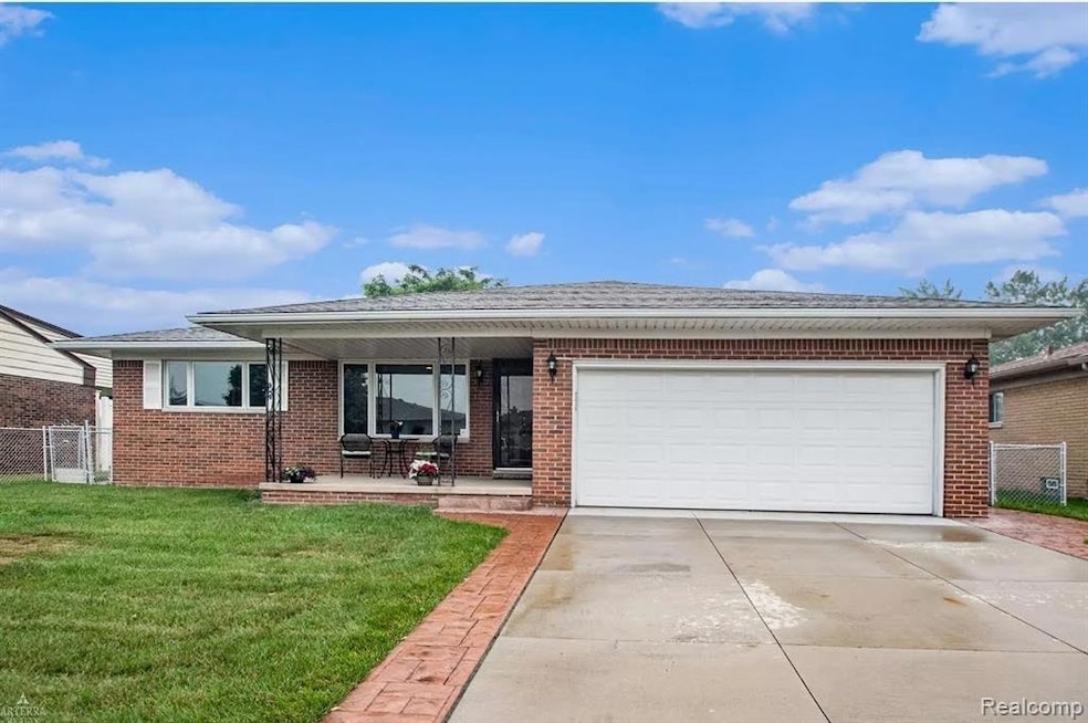 Ranch-style home with brick siding, concrete driveway, and an attached garage
