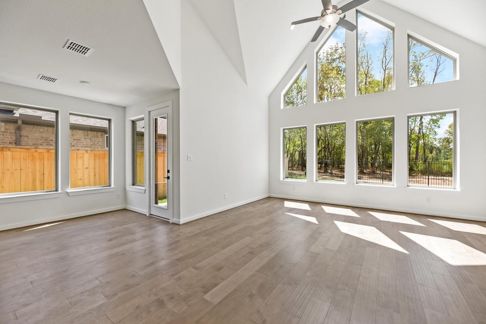 Newmarks Verona plan with beautiful A frame windows with views of trees from trail behind home.