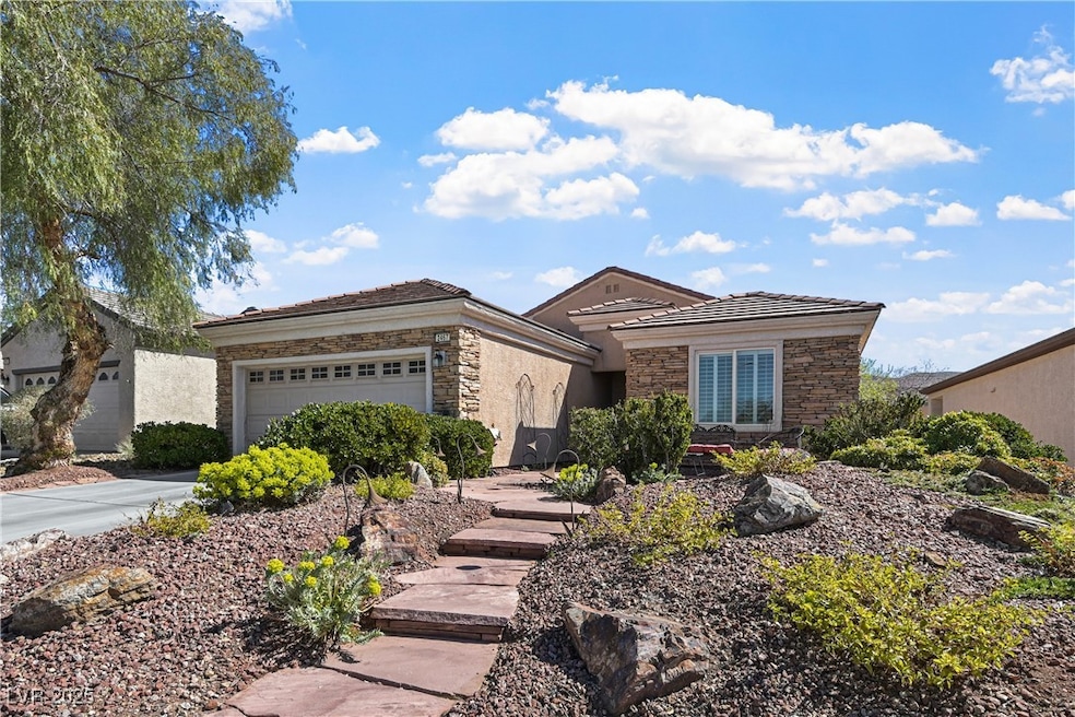 Single story home with stone siding and an attache