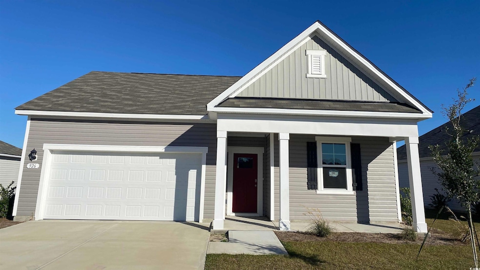 View of front facade featuring board and batten siding, a porch, driveway, a garage, and roof with shingles