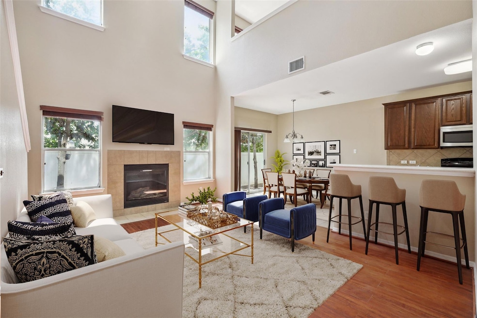Living room with visible vents, wood finished flo