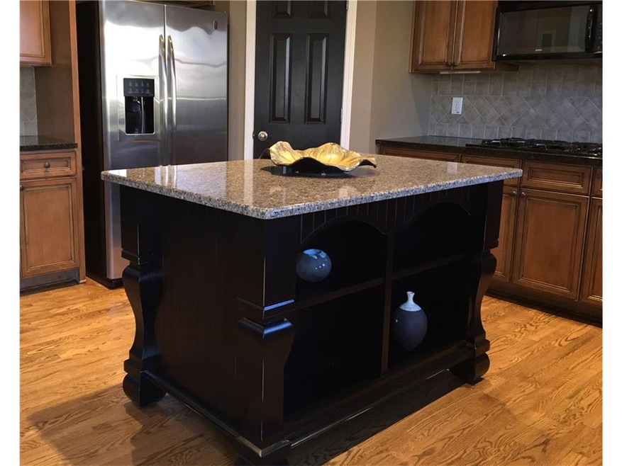 Gorgeous custom island, stained cabinets, granite,