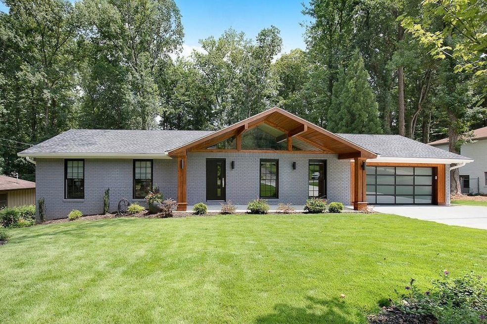 View of front of home featuring a garage and a front yard
