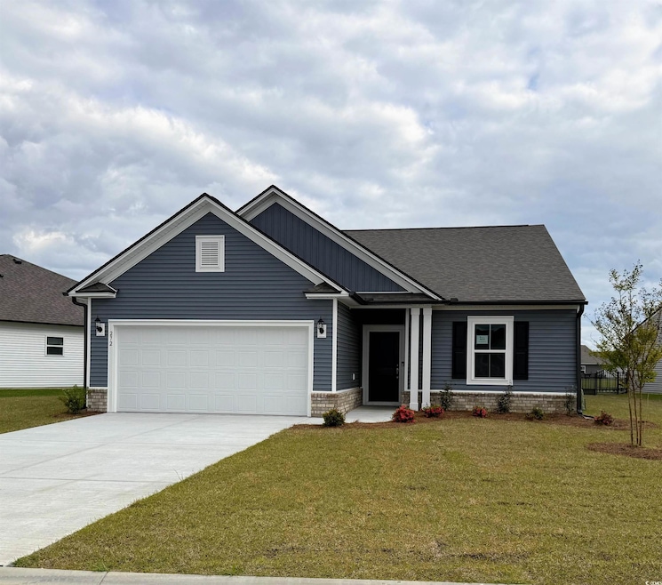 View of front facade featuring driveway, a garage, a front yard, and roof with shingles