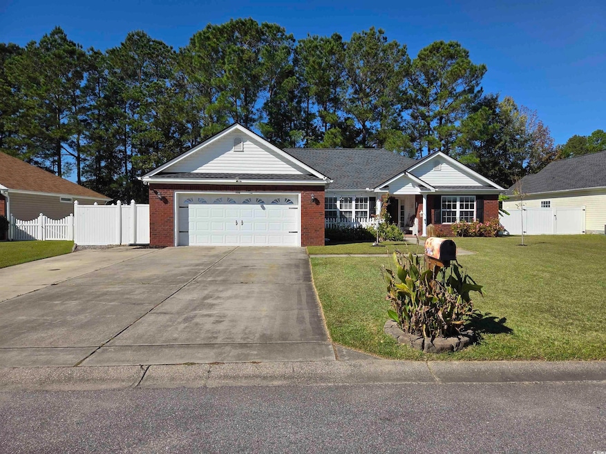 Single story home featuring brick siding, concrete driveway, and a garage