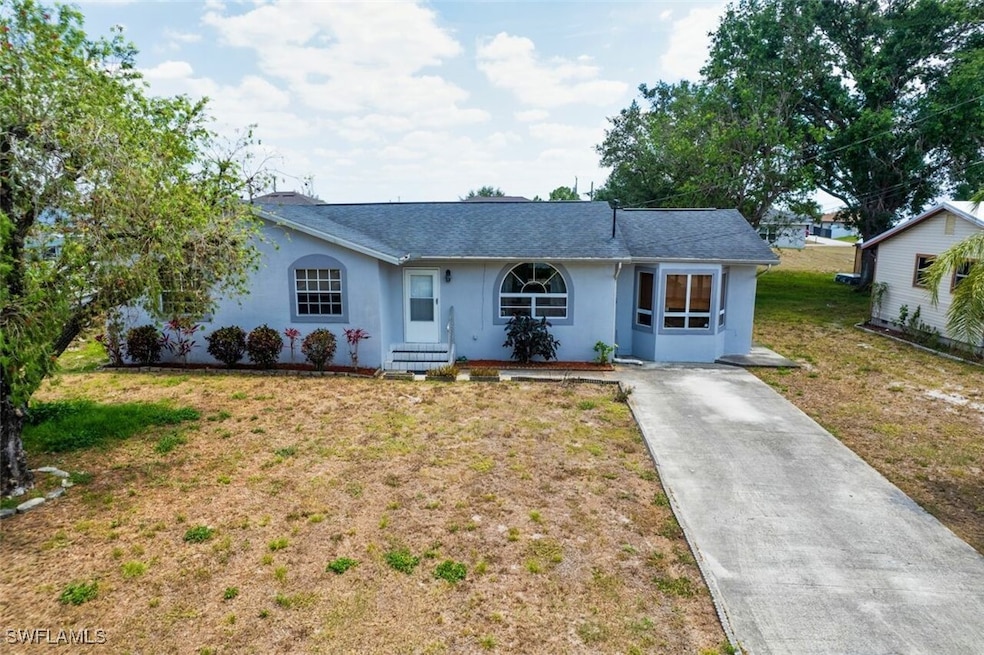 Ranch-style house featuring stucco siding, drivewa