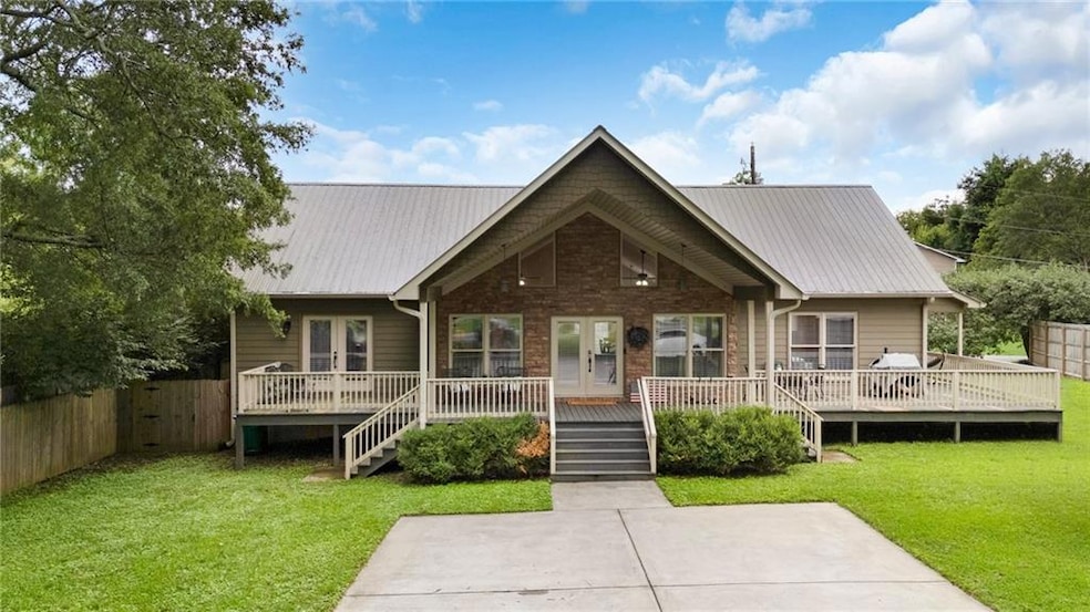 View of front of house with a deck, french doors, 