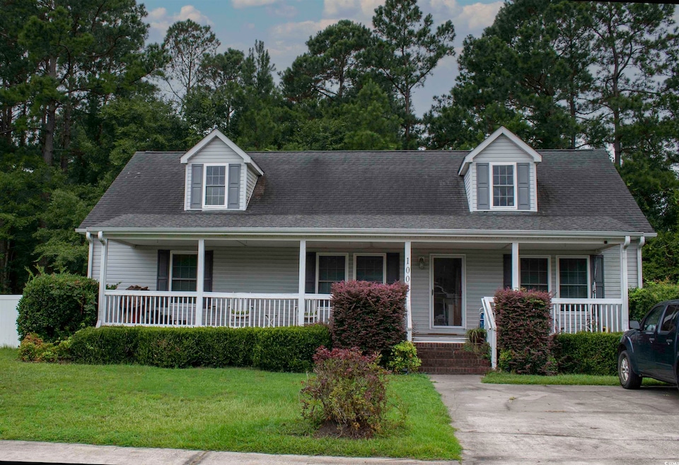 New england style home featuring a porch and a fro