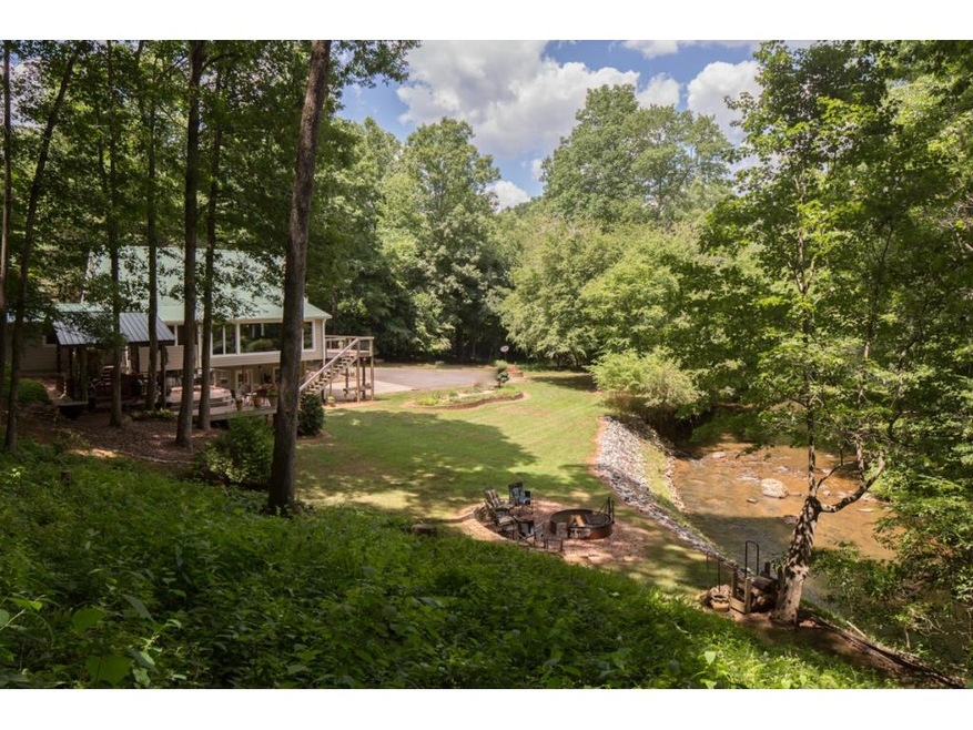 Picture perfect sitting on 3 private acres with lo