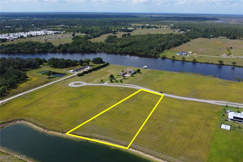 Birds eye view of property with a water view and a