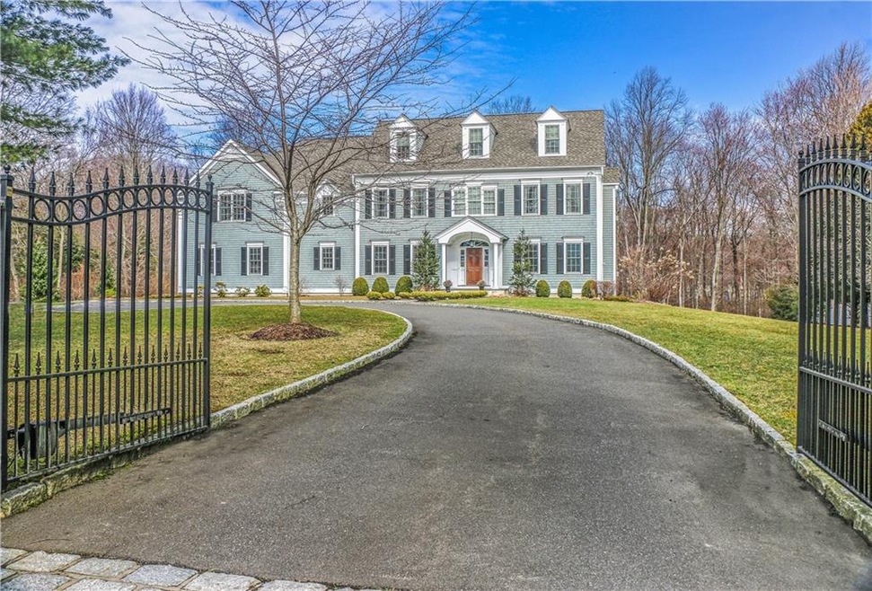 Enter through wrought iron gates to this prominent