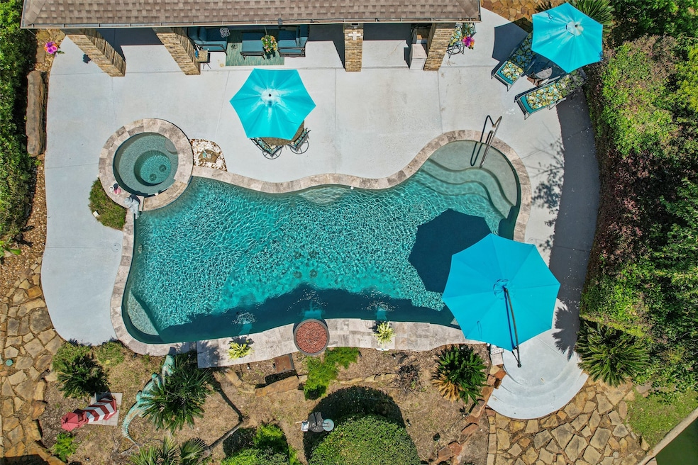 This aerial view of the sparkling pool and hot tub