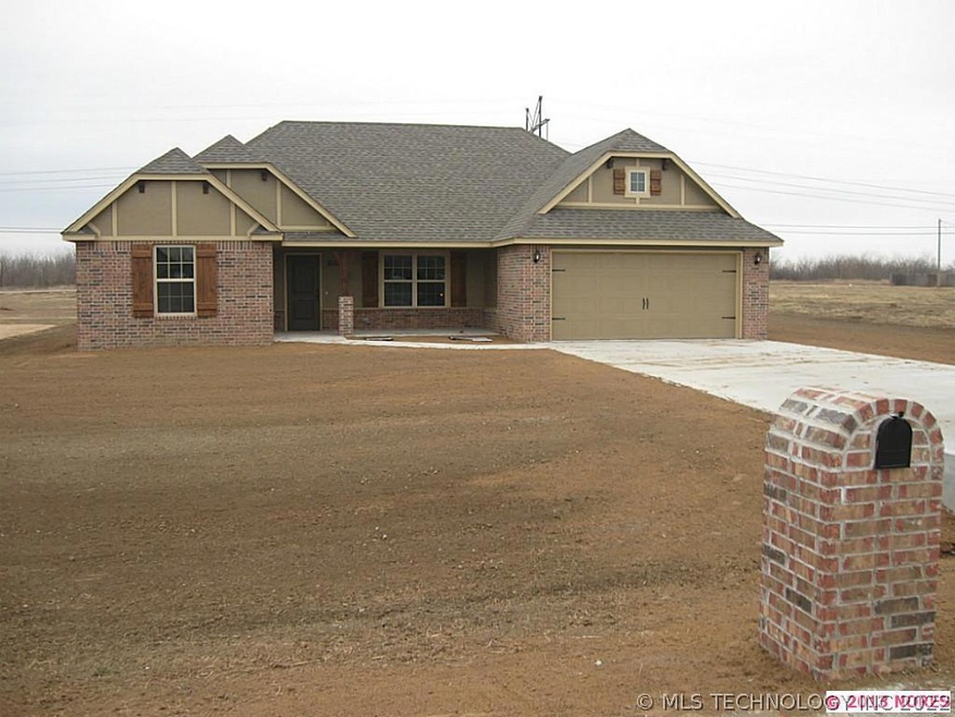 Front view. Stained shutters, brick porch column