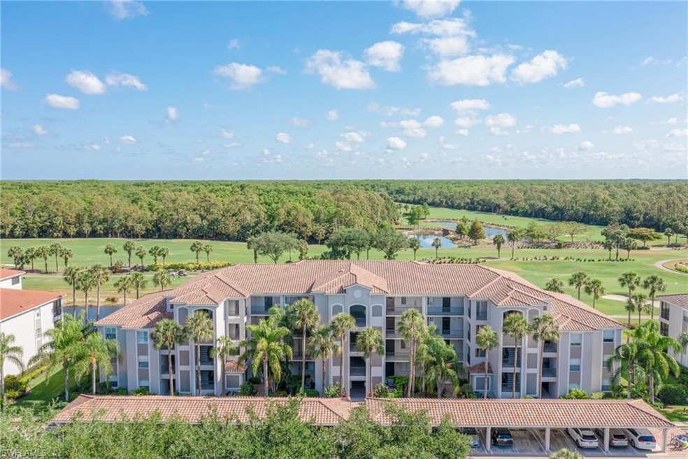 Birds eye view of property with a water view, golf