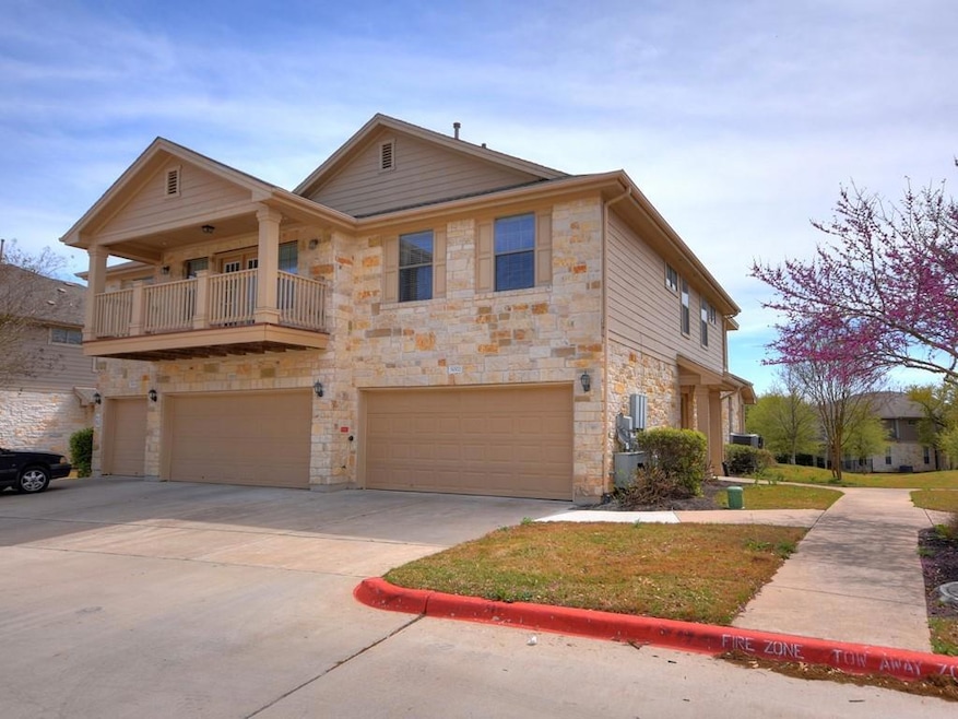 View of front of property featuring a garage, dri