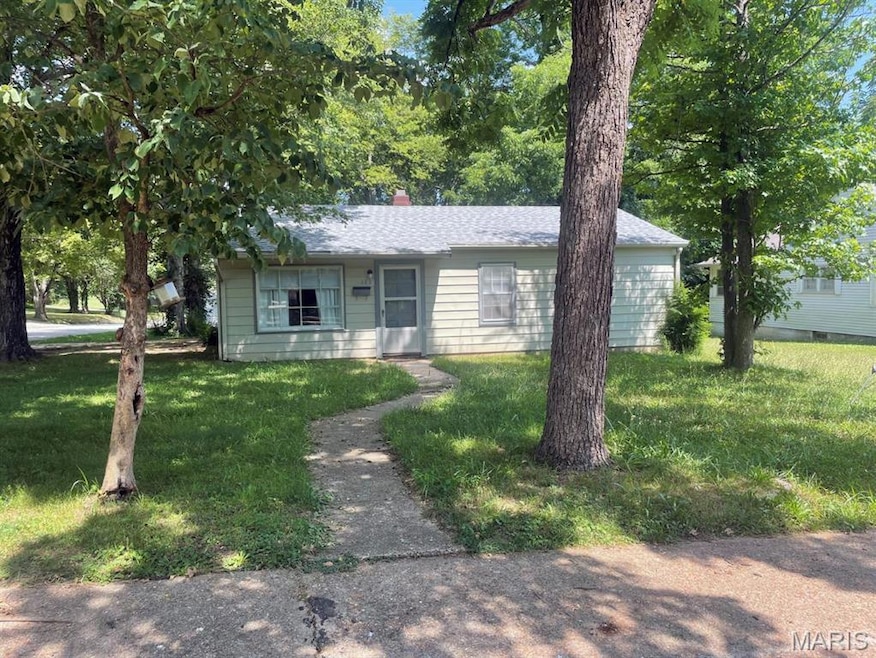 View of front of property featuring a front yard and a chimney