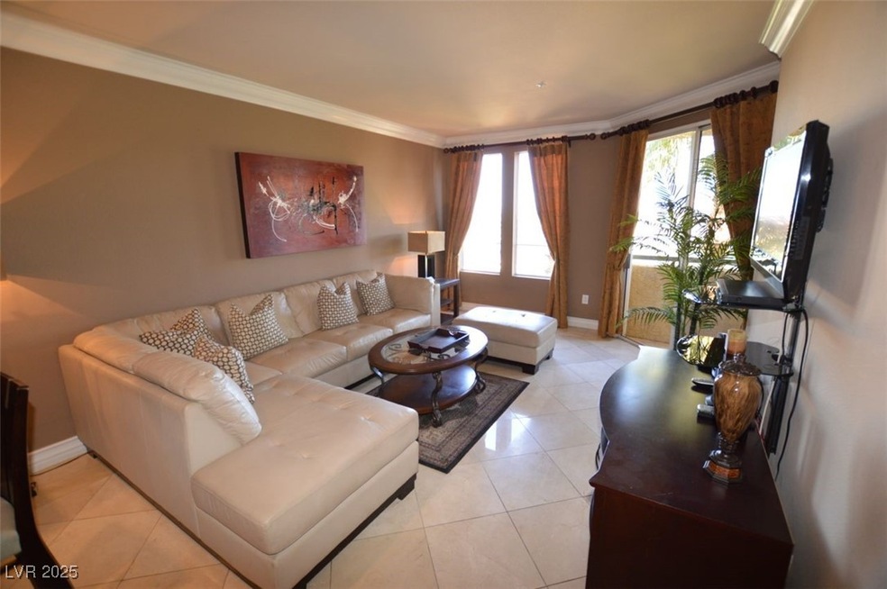 Living area featuring ornamental molding, baseboar