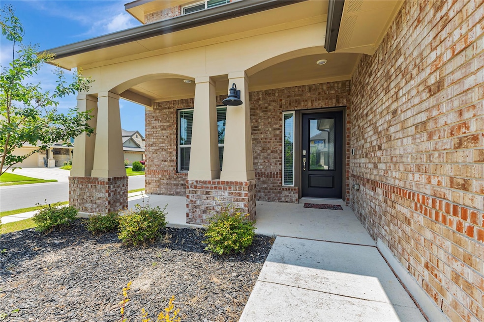 View of exterior entry featuring brick siding and