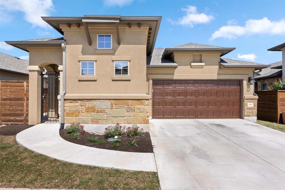 View of front of home with stone siding, a garage