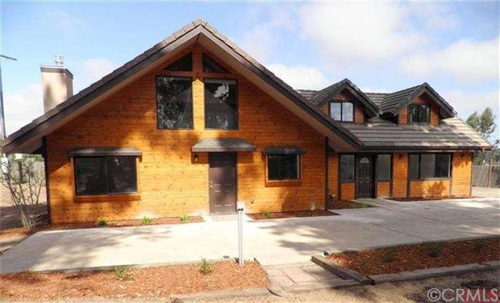 Front of home shows the beautiful wood, multiple w