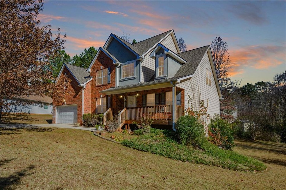 View of front of house featuring a lawn, a garage,