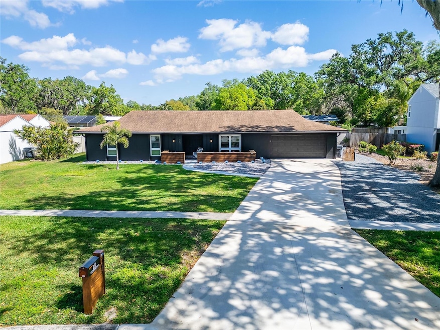 Modern Yet Classic Curb Appeal! Thoughtfully Chosen Paint Colors, Beautiful Woodwork, an Expansive Driveway, and an Extended Rock Gravel Drive Leading to the Backyard.