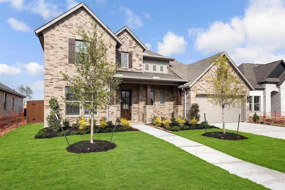 This is a modern two-story brick home featuring a