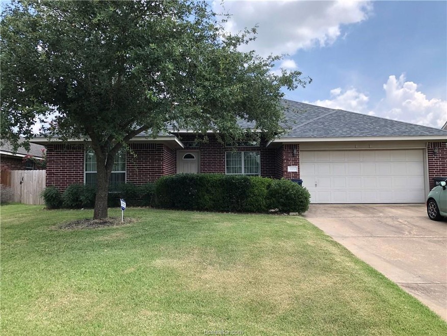 Single story home featuring brick siding, concrete driveway, an attached garage, and roof with shingles